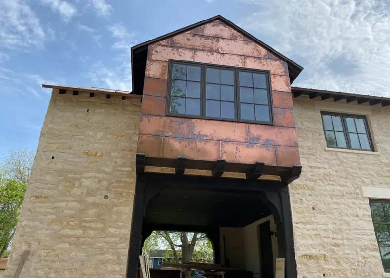 Copper metal panel facade on a stone building for Metal Roof Coating in Caln